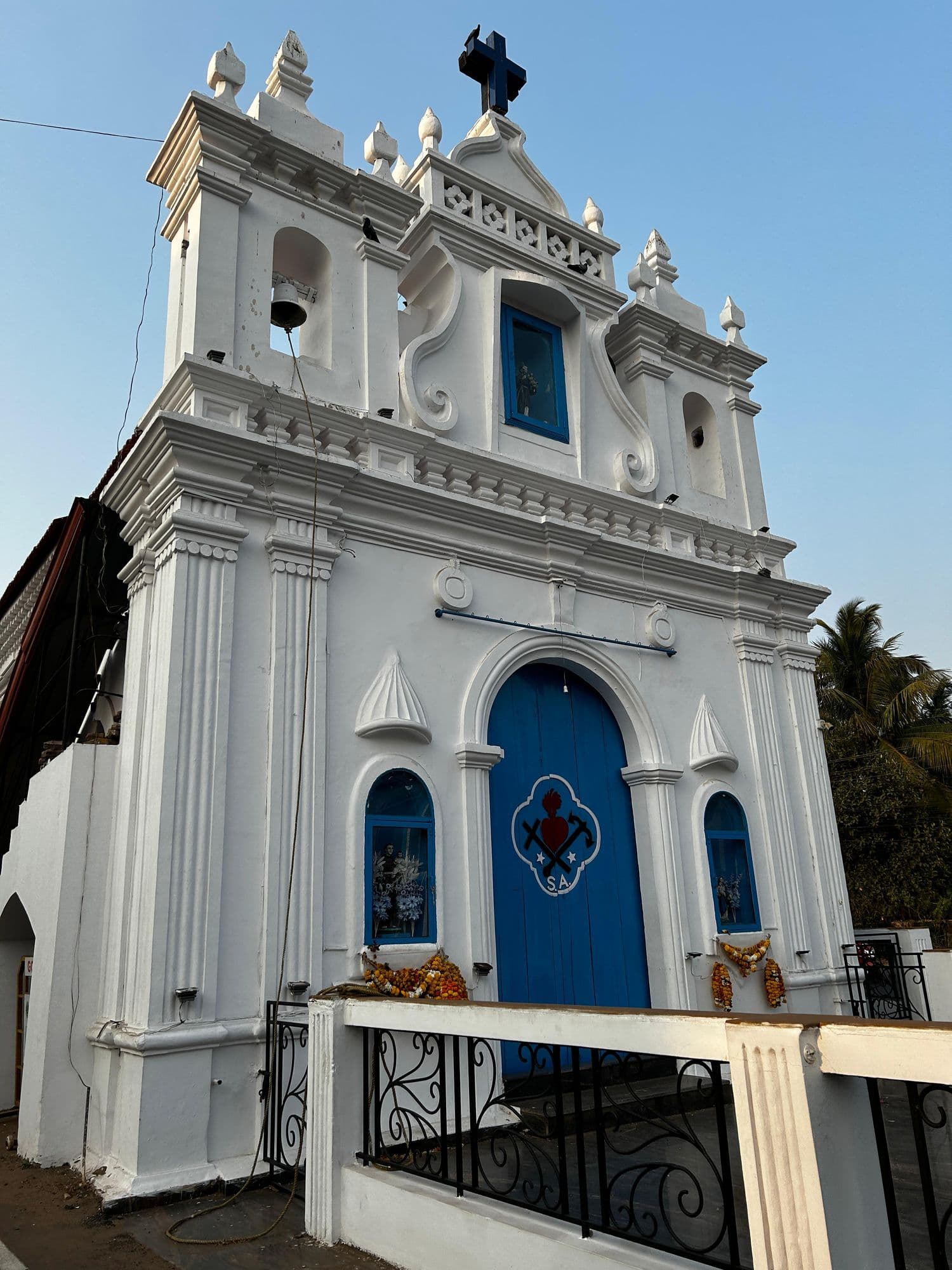 A whitewashed chapel with a blue door
