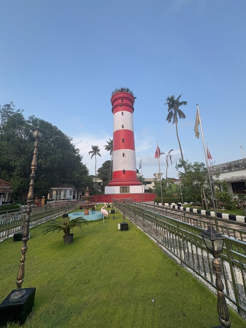 A coastal lighthouse among palms