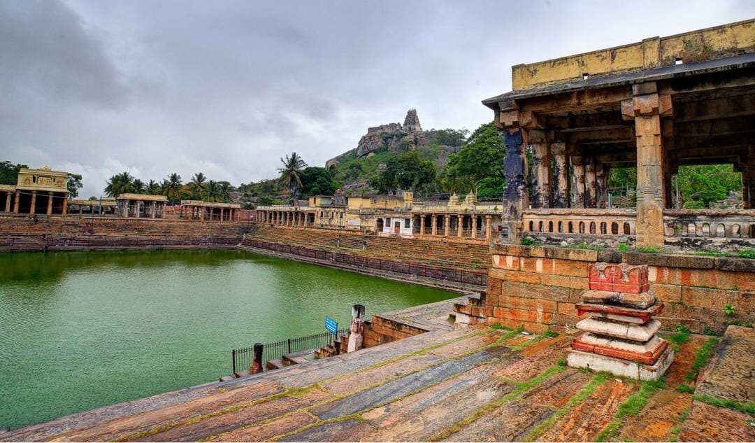 The stepped Kalyani tank at Melkote, with the hilltop temple beyond