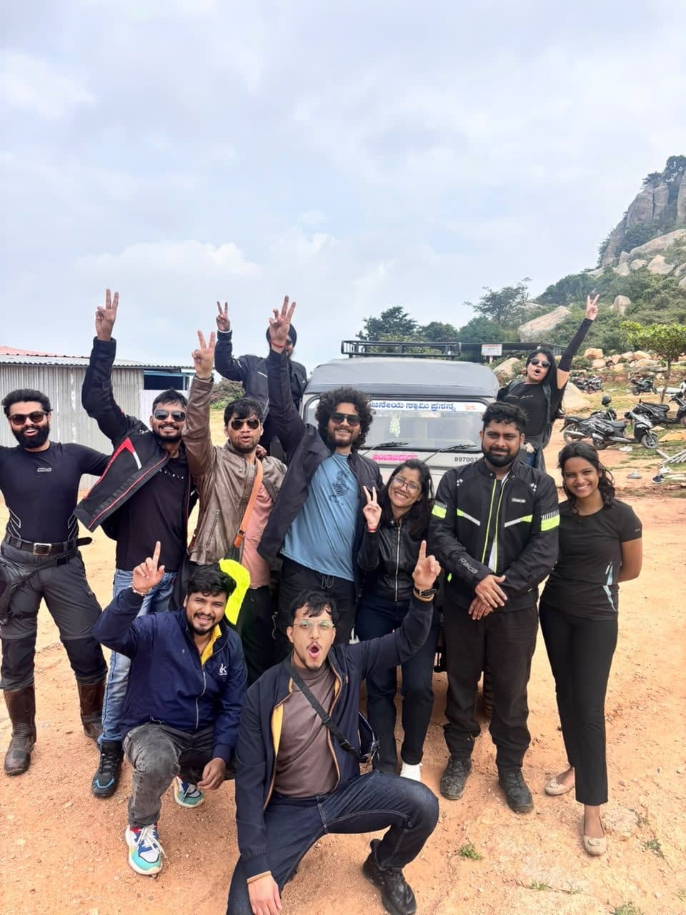 Group with bikes and a Tempo Traveller before departure