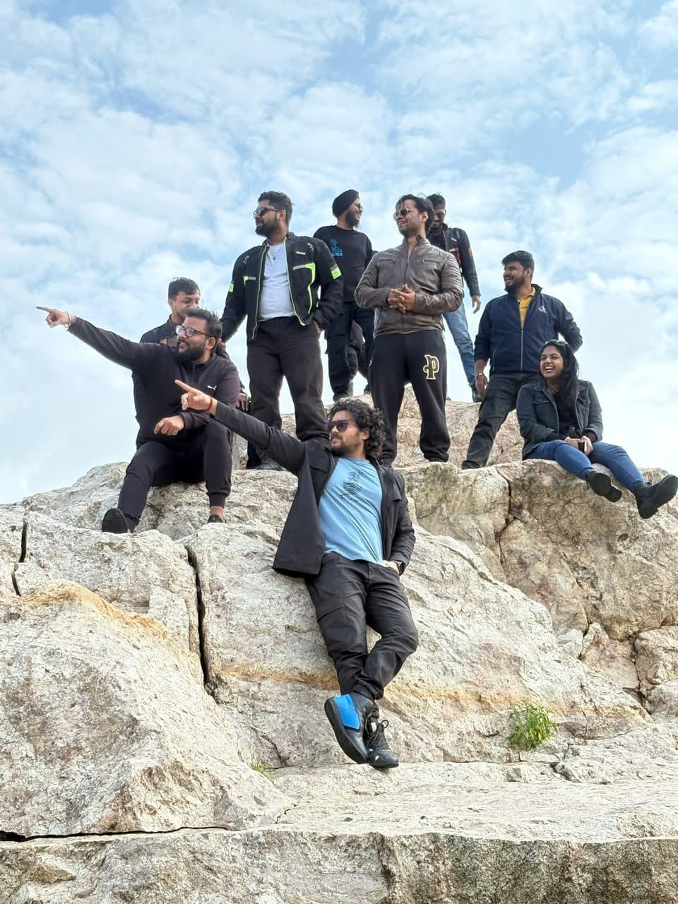 Trekkers on a granite rock face at sunrise